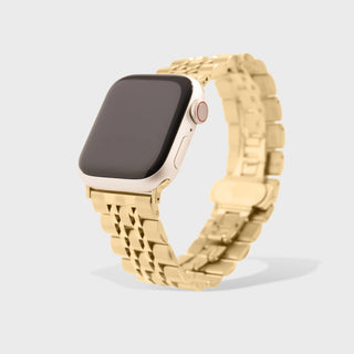 Smartwatch with a gold metal band on a light gray background