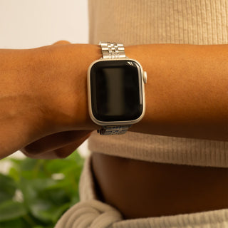 Person wearing a smartwatch on a blurred background