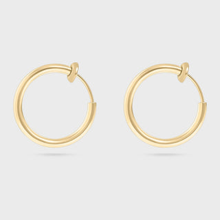 Gold hoop earrings on a light gray background