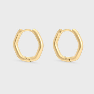 Gold hoop earrings on a light gray background