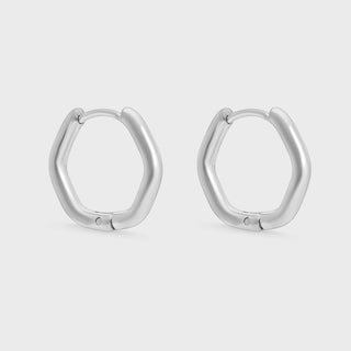Pair of silver hoop earrings on a light gray background