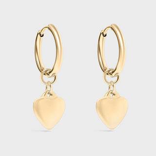 Gold hoop earrings with heart-shaped charms on a light gray background