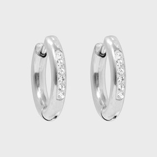 Silver hoop earrings with embedded stones on a light gray background