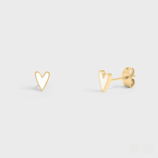Gold heart-shaped earrings on a light gray background
