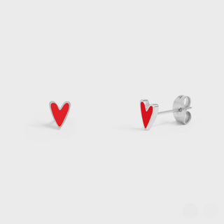 Red heart-shaped stud earrings on a light gray background