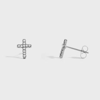 Silver cross-shaped stud earrings on a light gray background