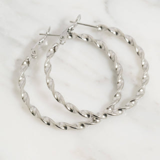 Silver hoop earrings on a white background