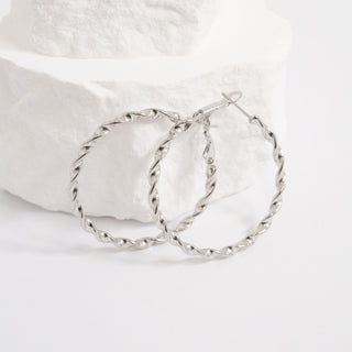 Silver hoop earrings on a white background