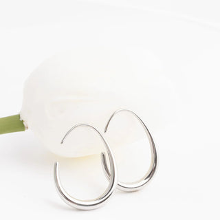 Silver hoop earrings on a white background