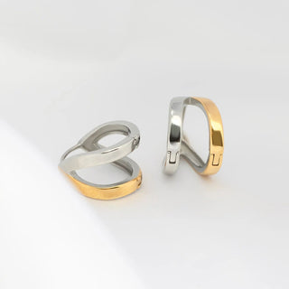 Two gold and silver rings on a light gray background
