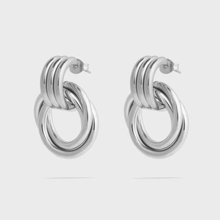 Pair of silver hoop earrings on a light gray background