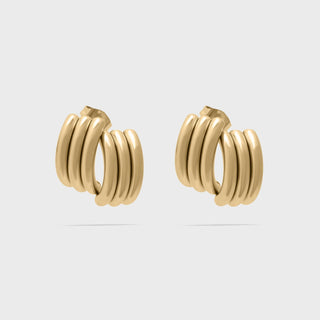 Pair of gold hoop earrings on a light gray background
