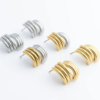 Set of gold and silver hoop earrings on a white background