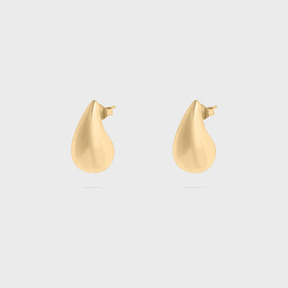 Gold teardrop-shaped earrings on a light gray background