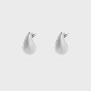 Pair of white teardrop-shaped earrings on a white background