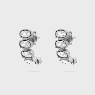 Pair of silver stud Oval Stone Huggie Earrings with clear gemstones on a white background