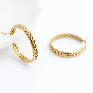 Pair of gold hoop earrings on a white background