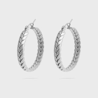 Pair of silver hoop earrings on a light gray background