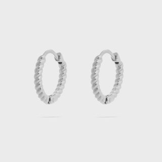 Pair of silver hoop earrings on a light gray background