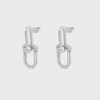 Pair of silver hoop earrings with pearl-like beads on a light gray background