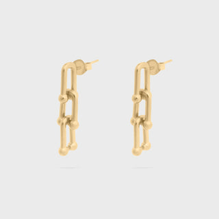 Gold chain-link earrings on a light gray background