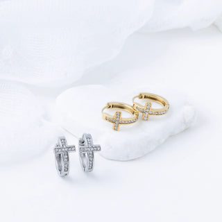 Pair of gold hoop earrings with cz stone accents on a white background