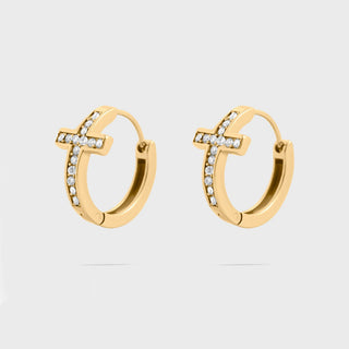 Gold cross hoop earrings with small cz stones on a light gray background