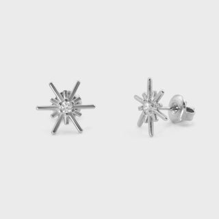 Silver firework earrings on a light gray background