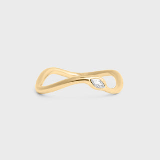 Gold ring with a diamond on a light gray background