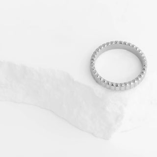 Silver ring on a white fabric background