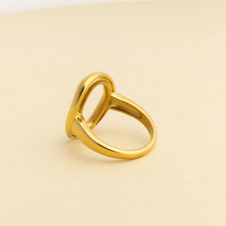 Gold ring on a beige background