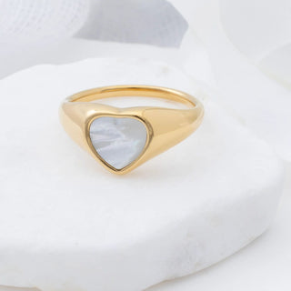 Gold ring with a heart-shaped MOP on a white background