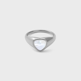 Silver ring with a heart-shaped MOP on a light gray background