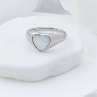 Silver ring with a heart-shaped MOP on a white background