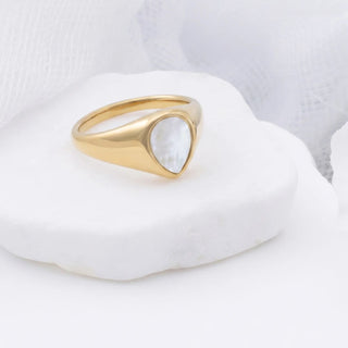Gold ring with a MOP on a white background