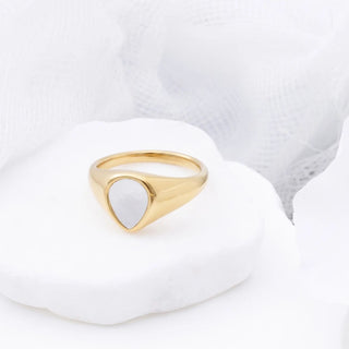 Gold ring with a MOP on a white background