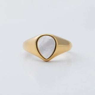 Gold ring with a MOP on a light gray background