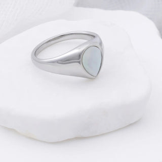 Silver ring with a teardrop MOP on a white background