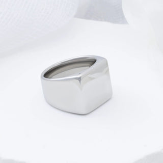 Silver square signet ring on a white background