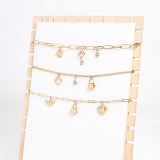 Heart With Cubic Zirconia Charm with other charms and chains on display
