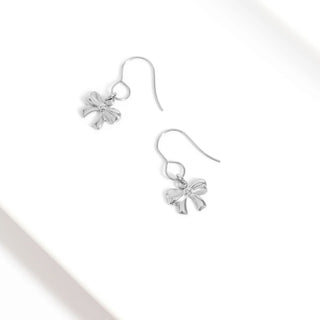 Silver bow-shaped earrings on a white background
