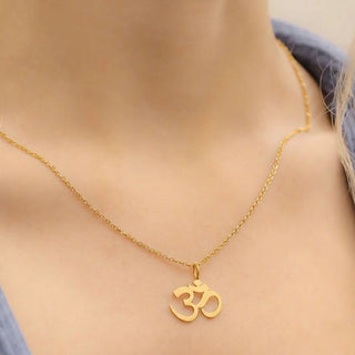 Gold necklace with Om pendant around a neck
