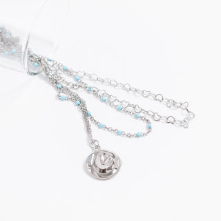 Silver necklace with a cowboy hat  pendant on a white background