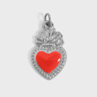 Silver pendant with a red heart on a white background