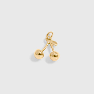 Gold cherry-shaped pendant on a light gray background