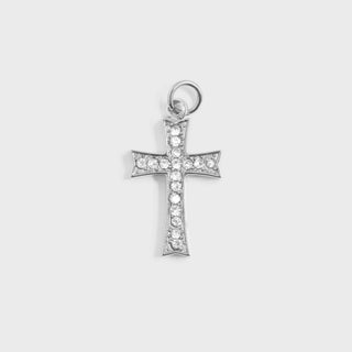 Silver cross pendant with clear stones on a light gray background