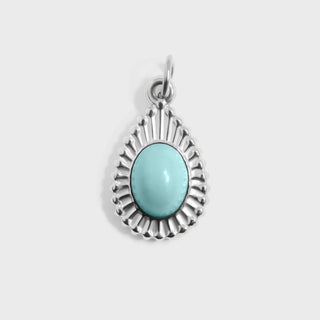 Silver pendant with a turquoise stone on a white background