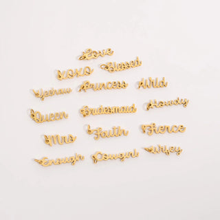 Gold decorative letters spelling out various words on a white background
