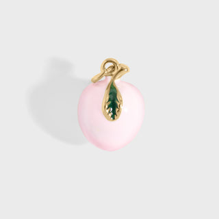 Pink peach pendant with gold and green accents on a light gray background