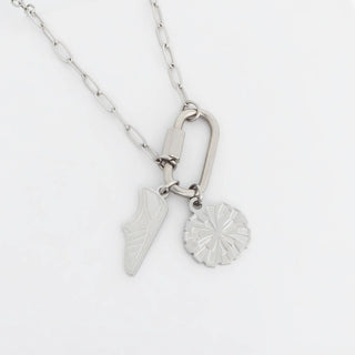 Silver necklace with two pendants on a white background
